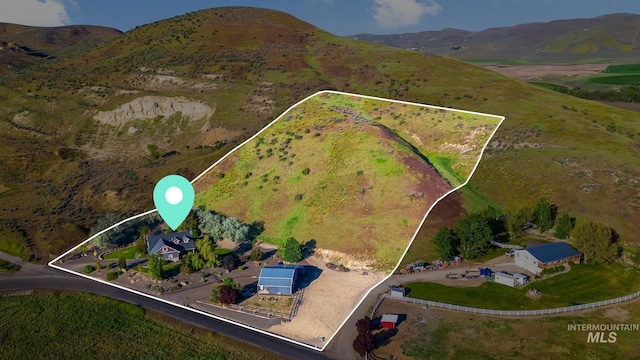 aerial view of property's location featuring property boundaries highlighted and a mountain backdrop