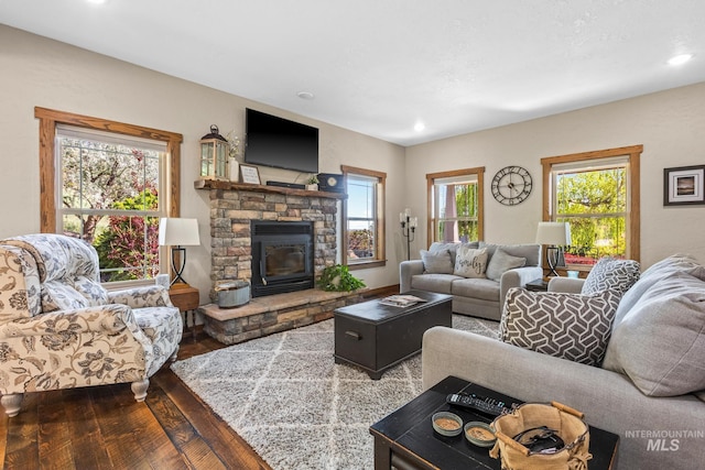 living area with hardwood / wood-style flooring, a fireplace, and recessed lighting