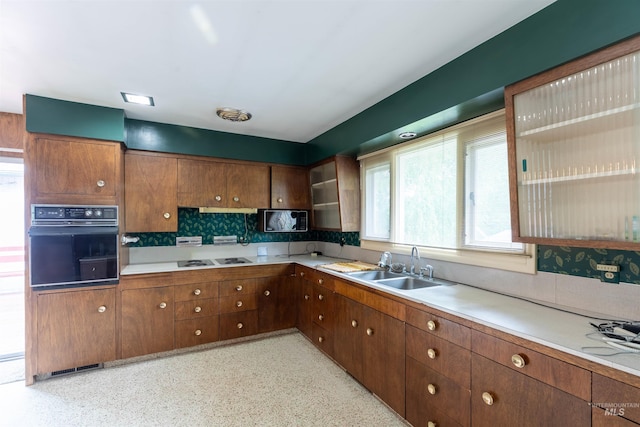904 Lewis St, Moscow, ID 83843 - kitchen featuring black oven, backsplash, a sink, light countertops, and electric cooktop