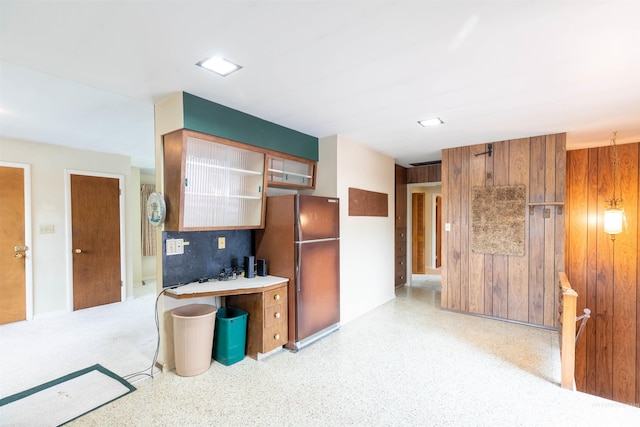 904 Lewis St, Moscow, ID 83843 - kitchen featuring freestanding refrigerator, wooden walls, and light countertops