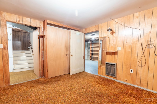 904 Lewis St, Moscow, ID 83843 - unfurnished bedroom with heating unit, carpet flooring, wood walls, and a closet