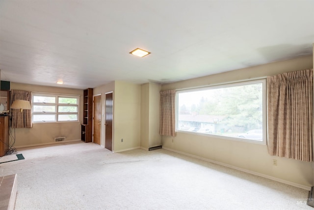 904 Lewis St, Moscow, ID 83843 - unfurnished living room featuring baseboards and carpet