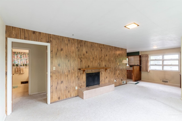 904 Lewis St, Moscow, ID 83843 - unfurnished living room featuring wooden walls, carpet, a fireplace, and baseboards