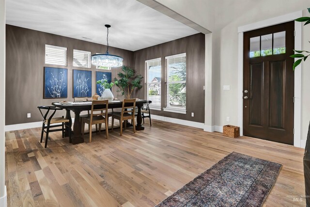 2043 E Lodge Trail Dr, Meridian, ID 83642 - dining area featuring a chandelier, wood finished floors, and baseboards