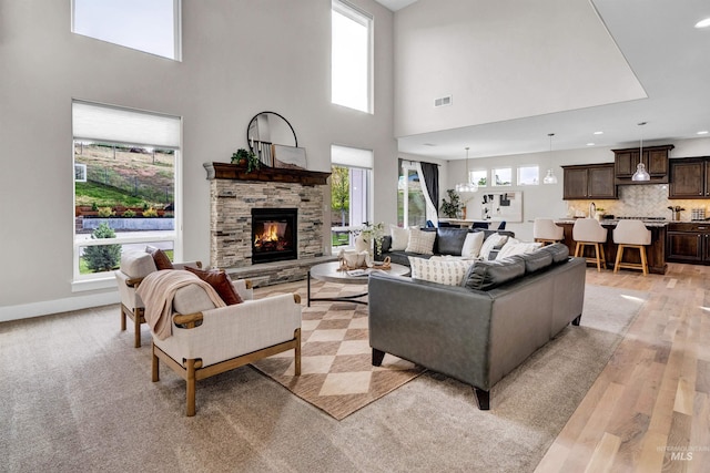 2043 E Lodge Trail Dr, Meridian, ID 83642 - living room with light wood finished floors, a high ceiling, a fireplace, recessed lighting, and baseboards