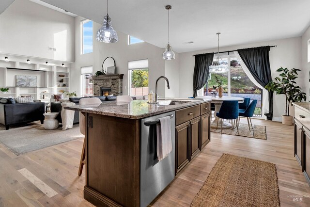 2043 E Lodge Trail Dr, Meridian, ID 83642 - kitchen with a sink, stainless steel dishwasher, dark brown cabinets, plenty of natural light, and a high ceiling