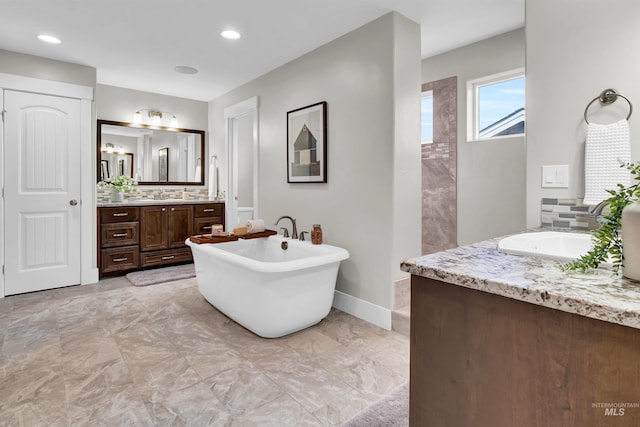 2043 E Lodge Trail Dr, Meridian, ID 83642 - full bath featuring a freestanding bath, two vanities, decorative backsplash, baseboards, and recessed lighting