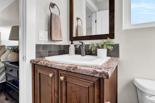 2043 E Lodge Trail Dr, Meridian, ID 83642 - half bathroom featuring decorative backsplash, toilet, and vanity
