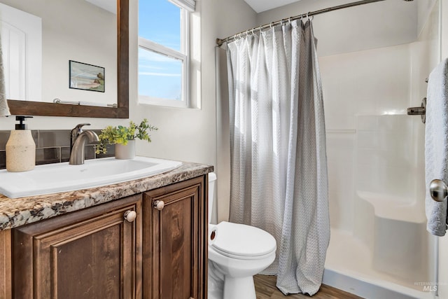 2043 E Lodge Trail Dr, Meridian, ID 83642 - bathroom with a shower with shower curtain, toilet, wood finished floors, and vanity