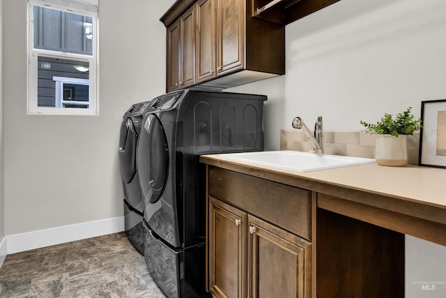 2043 E Lodge Trail Dr, Meridian, ID 83642 - clothes washing area with washer and dryer, cabinet space, baseboards, and stone finish floors