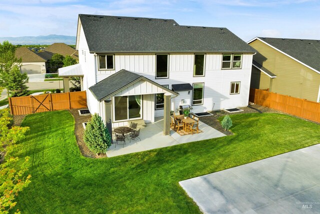 2043 E Lodge Trail Dr, Meridian, ID 83642 - rear view of house with board and batten siding, roof with shingles, and a patio