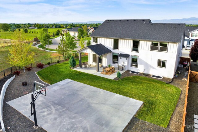 2043 E Lodge Trail Dr, Meridian, ID 83642 - back of house featuring a mountain view, board and batten siding, a shingled roof, and a patio