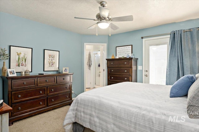bedroom featuring light colored carpet, ceiling fan, and connected bathroom