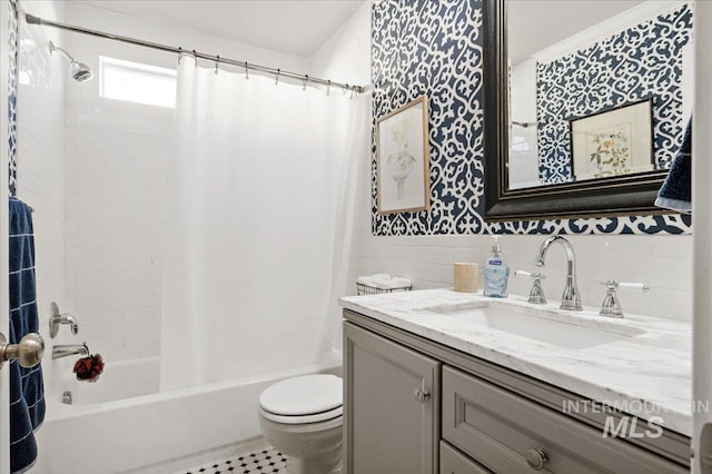 full bathroom with toilet, vanity, and shower / bath combo with shower curtain