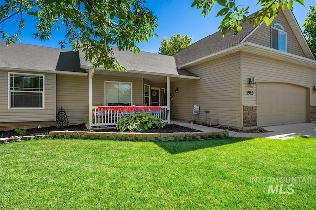 view of front of house with a front lawn, driveway, a porch, and stone siding