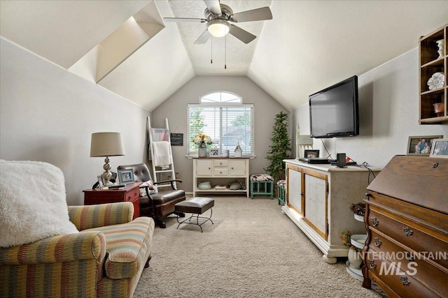 interior space with vaulted ceiling, carpet, and a ceiling fan