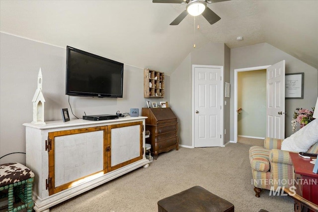 living room featuring ceiling fan, vaulted ceiling, baseboards, and carpet