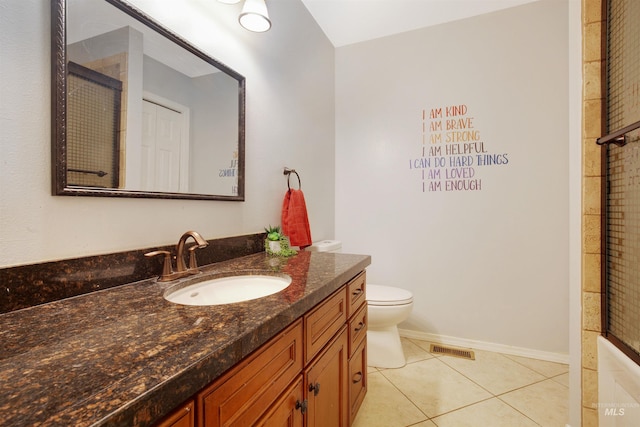 426 Carriage Ln, Twin Falls, ID 83301 - full bath with tile patterned floors, vanity, toilet, an enclosed shower, and baseboards
