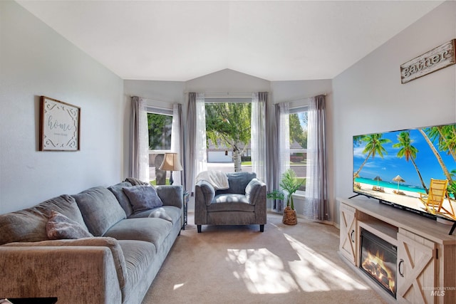 426 Carriage Ln, Twin Falls, ID 83301 - living room with vaulted ceiling, light carpet, and a glass covered fireplace