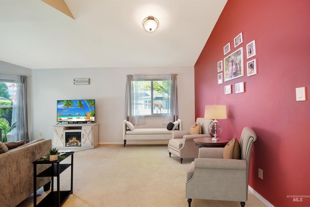426 Carriage Ln, Twin Falls, ID 83301 - carpeted living area with a lit fireplace, lofted ceiling, and baseboards