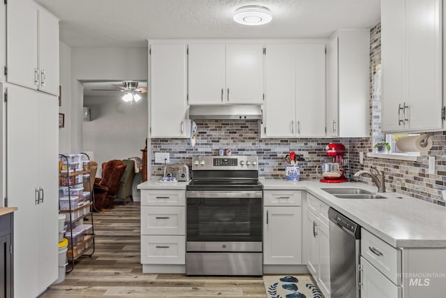 2208 Keithley Creek Rd, Midvale, ID 83645 - kitchen featuring stainless steel appliances, light countertops, under cabinet range hood, white cabinets, and a textured ceiling