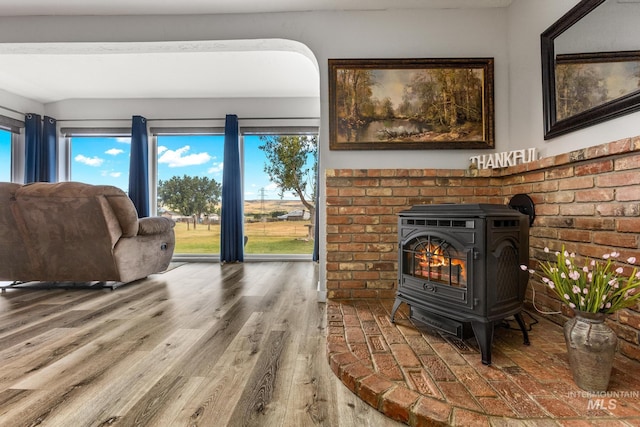 2208 Keithley Creek Rd, Midvale, ID 83645 - living room featuring a wood stove, healthy amount of natural light, and wood finished floors
