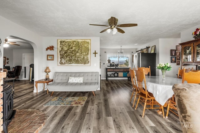 2208 Keithley Creek Rd, Midvale, ID 83645 - dining area with ceiling fan, wood finished floors, arched walkways, and a textured ceiling