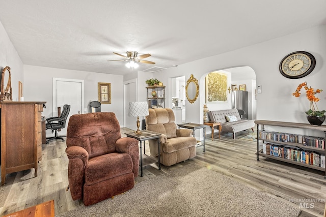 2208 Keithley Creek Rd, Midvale, ID 83645 - living area featuring wood finished floors, ceiling fan, and arched walkways