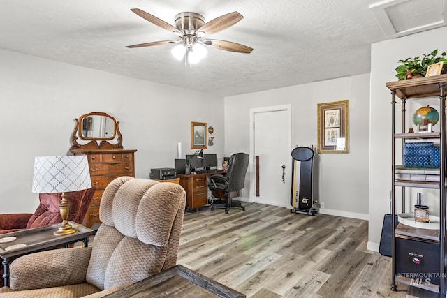 2208 Keithley Creek Rd, Midvale, ID 83645 - home office featuring light wood-style floors, ceiling fan, a textured ceiling, and attic access