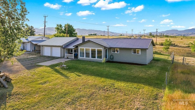 2208 Keithley Creek Rd, Midvale, ID 83645 - rear view of house featuring a metal roof, a mountain view, and driveway