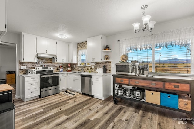 2208 Keithley Creek Rd, Midvale, ID 83645 - kitchen featuring appliances with stainless steel finishes, under cabinet range hood, white cabinets, light countertops, and a textured ceiling