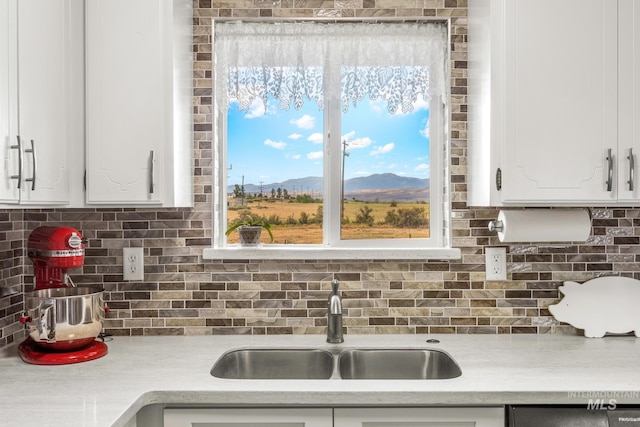 2208 Keithley Creek Rd, Midvale, ID 83645 - kitchen with light countertops, backsplash, white cabinets, and a mountain view