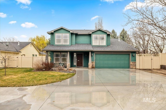 2030 W Cabot Ave, Nampa, ID 83686 - craftsman-style home with a front lawn, fence, stone siding, driveway, and a gate