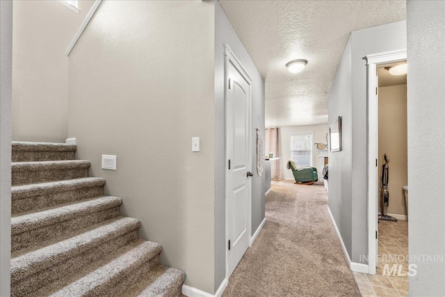 2030 W Cabot Ave, Nampa, ID 83686 - stairway with baseboards, a textured ceiling, carpet, and a textured wall