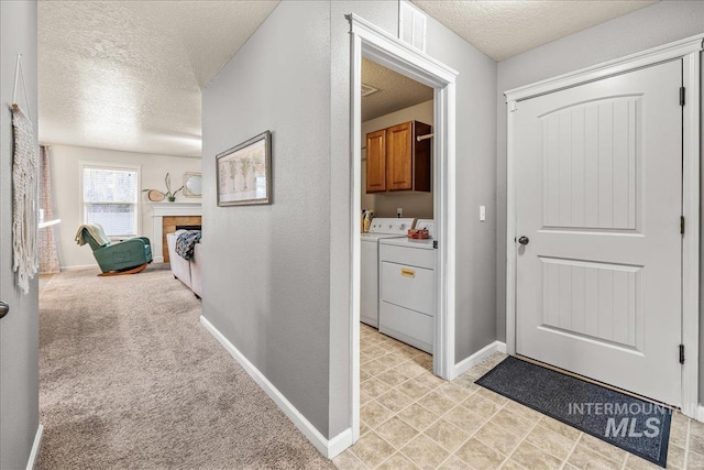 2030 W Cabot Ave, Nampa, ID 83686 - hallway with baseboards, light carpet, separate washer and dryer, and a textured ceiling