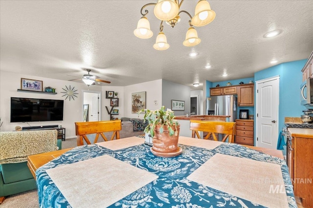 2030 W Cabot Ave, Nampa, ID 83686 - dining space with a textured ceiling, light colored carpet, and ceiling fan with notable chandelier