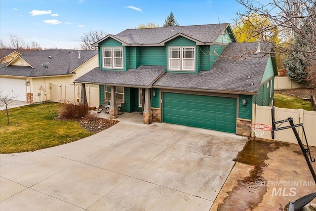2030 W Cabot Ave, Nampa, ID 83686 - view of front of house with an attached garage, roof with shingles, and fence