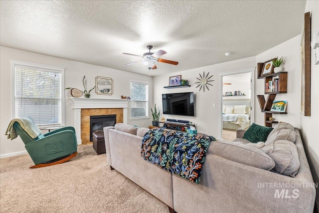 2030 W Cabot Ave, Nampa, ID 83686 - carpeted living room with baseboards, a fireplace, a textured ceiling, and ceiling fan
