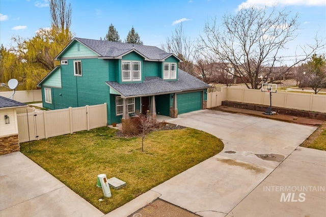 2030 W Cabot Ave, Nampa, ID 83686 - view of front of house with an attached garage, concrete driveway, a front lawn, and fence
