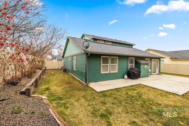 2030 W Cabot Ave, Nampa, ID 83686 - rear view of property featuring a shingled roof, a lawn, a fenced backyard, and a patio area