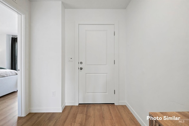 corridor with light wood-type flooring