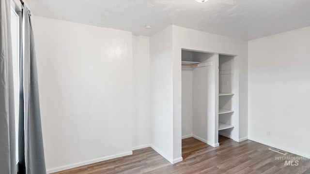 219 14th Ave N, Nampa, ID 83687 - unfurnished bedroom with wood finished floors, a closet, and baseboards