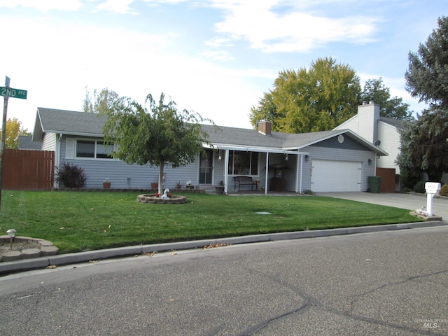 single story home featuring an attached garage, fence, a front lawn, and concrete driveway