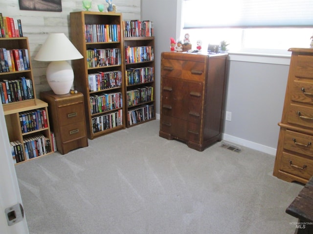 sitting room featuring carpet and baseboards