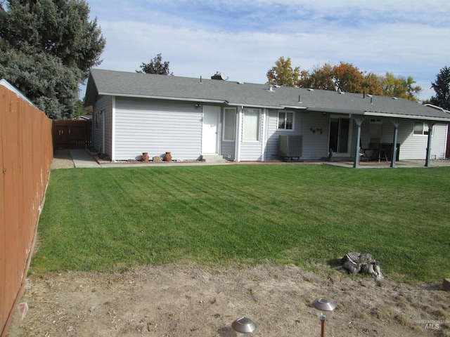 back of property featuring a patio, a lawn, a fenced backyard, and central air condition unit