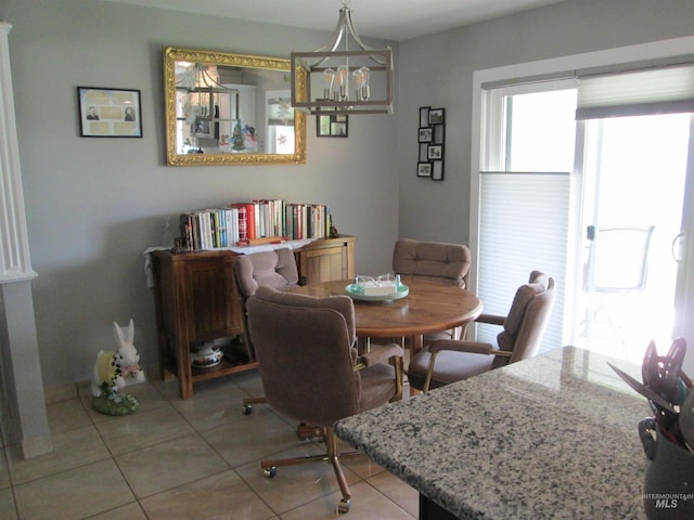 dining room with a notable chandelier and light tile patterned floors