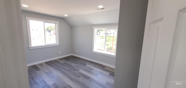 empty room featuring lofted ceiling and dark hardwood / wood-style flooring