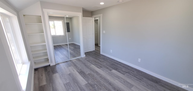 unfurnished bedroom featuring a closet and hardwood / wood-style flooring