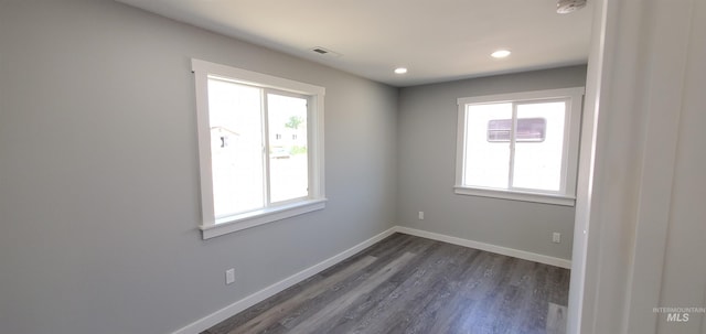 empty room with dark hardwood / wood-style floors