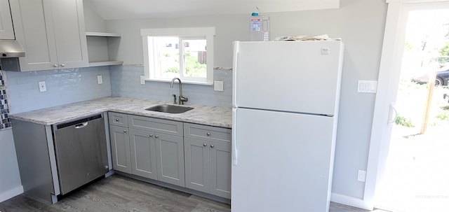 kitchen with white fridge, stainless steel dishwasher, sink, and gray cabinetry